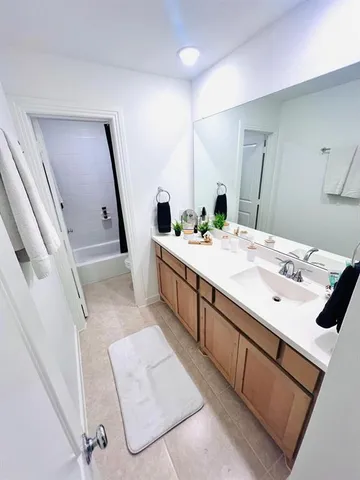 a room with a sink and a mirror