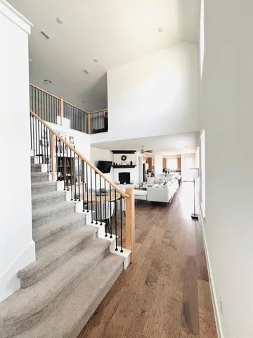 a living room with lots of furniture and stairs