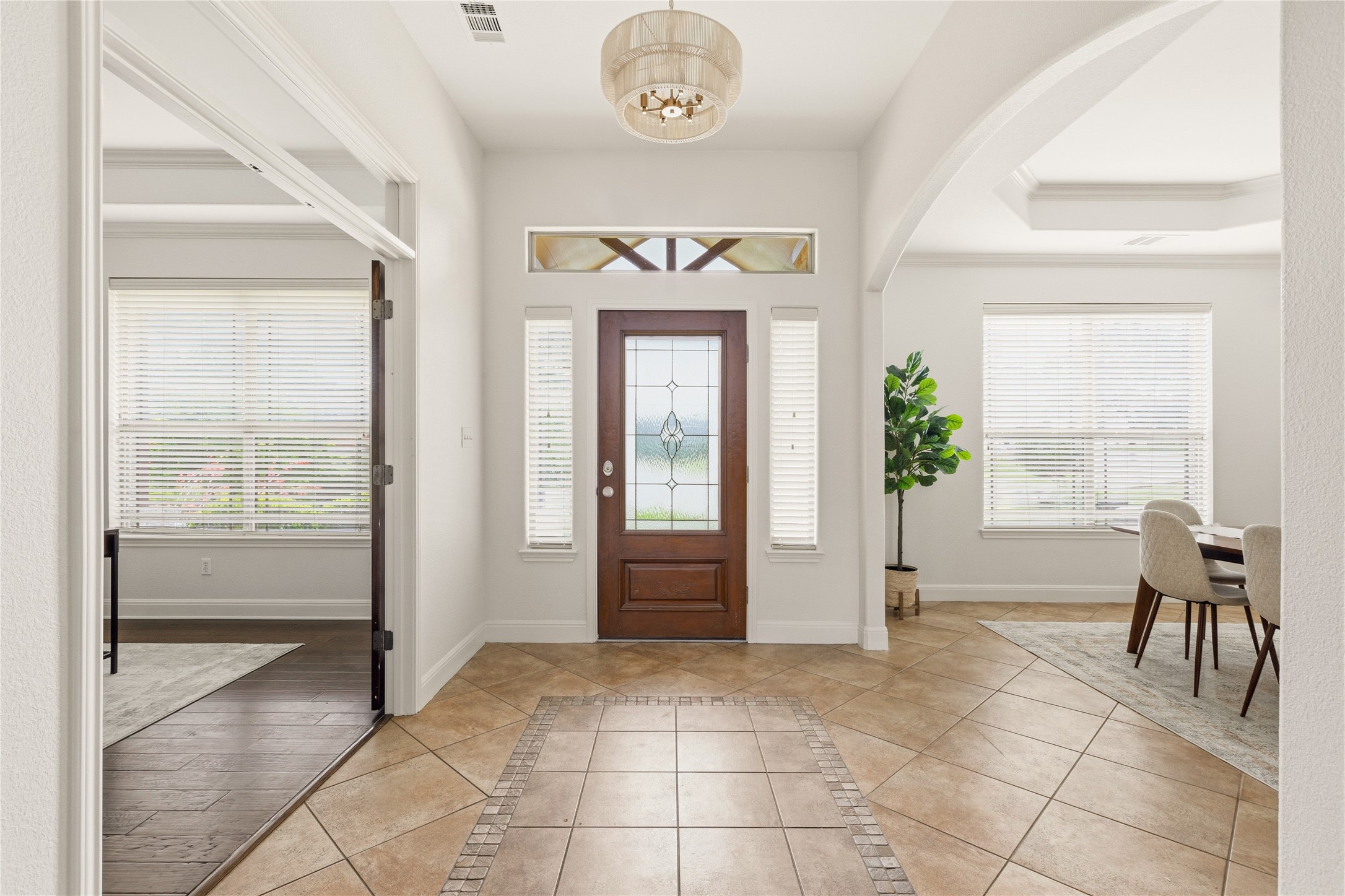 1432 Tom Sawyer Road Austin, TX 78737 - Photo 4 of 33 A welcoming entryway with a tile inlay and decorative light fixture leads to open living spaces.
