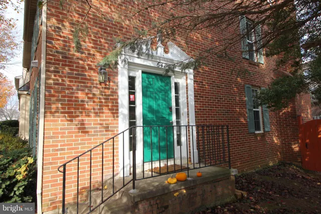 a view of a porch with a floor to ceiling window and tree