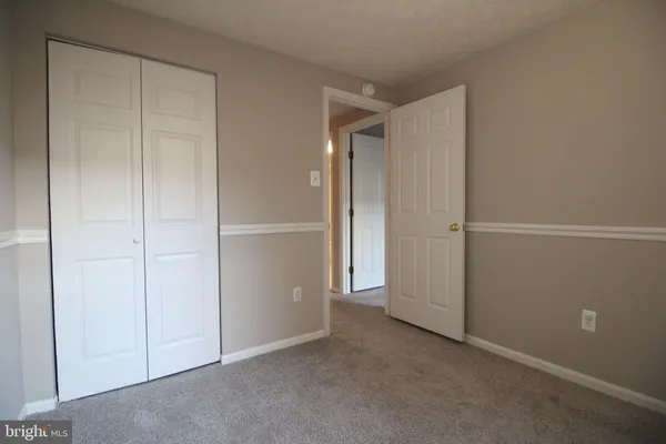 an empty room with closet area