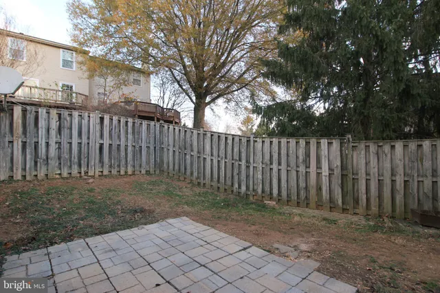 a view of a backyard with wooden fence