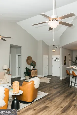 a living room with dining table and chairs