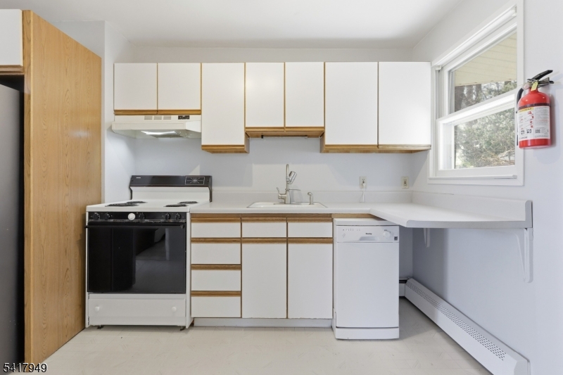10 Minnehaha Path Lincoln Park, NJ 07035 - Photo 12 of 32 a kitchen with a cabinets and white appliances