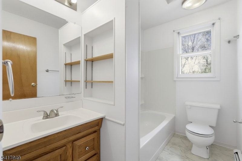 10 Minnehaha Path Lincoln Park, NJ 07035 - Photo 20 of 32 a bathroom with a sink toilet a tub and shower