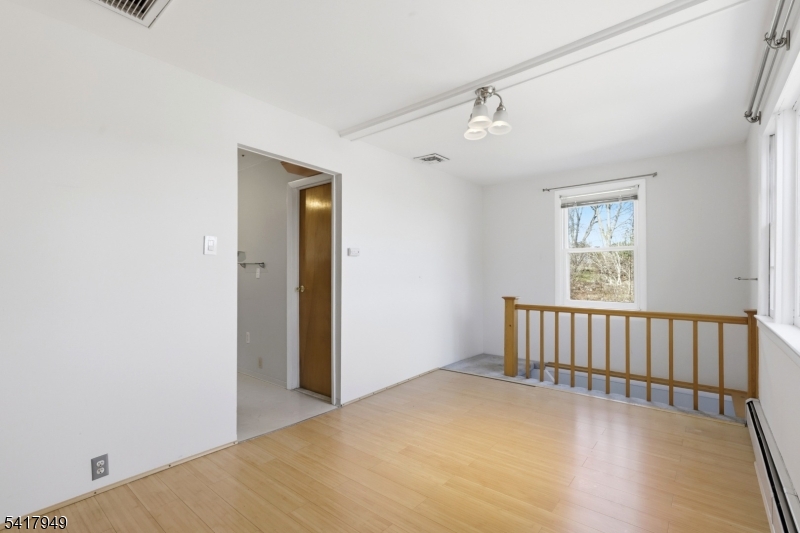 10 Minnehaha Path Lincoln Park, NJ 07035 - Photo 4 of 32 a view of an empty room with wooden floor and a window