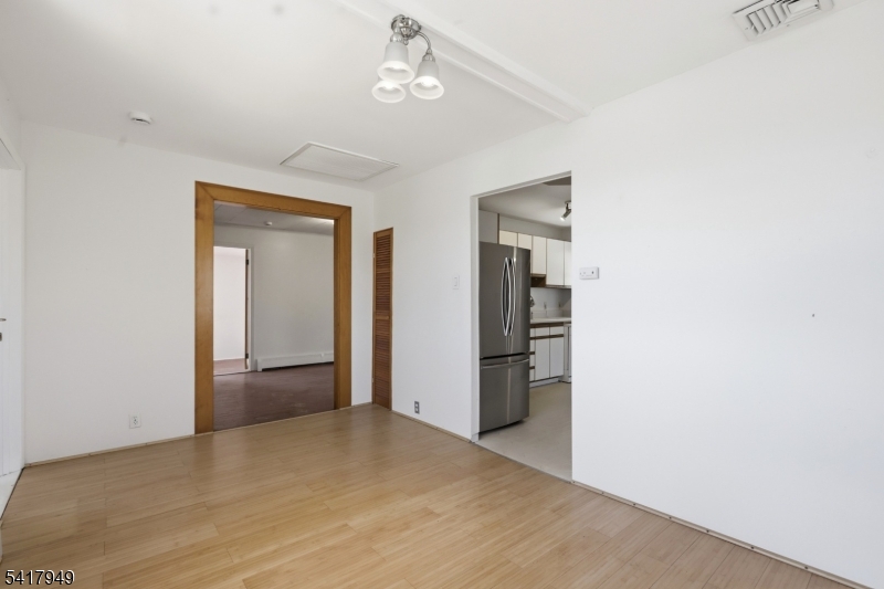 10 Minnehaha Path Lincoln Park, NJ 07035 - Photo 6 of 32 a view of empty room with wooden floor and ceiling fan