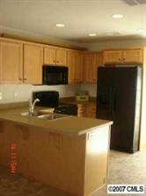 1911 Sandal Brook Road, Unit 115 Fort Mill, SC 29707 - Photo 2 of 4 a kitchen with a refrigerator and a stove