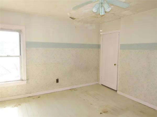 an empty room with wooden floor