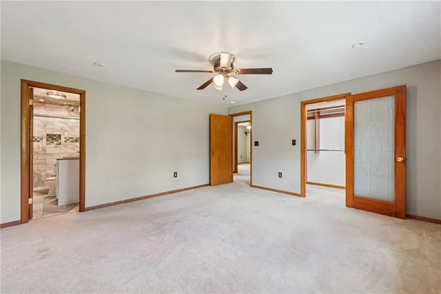 a view of a room with chandelier fan and windows