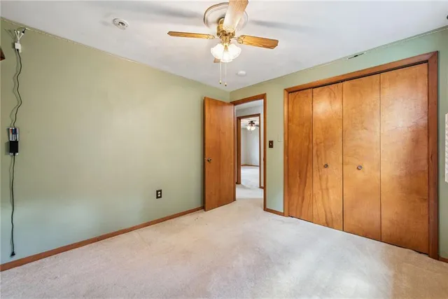a view of a room with a ceiling fan and a window