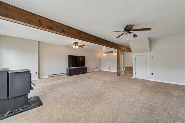 a view of a livingroom with a fireplace and a chandelier