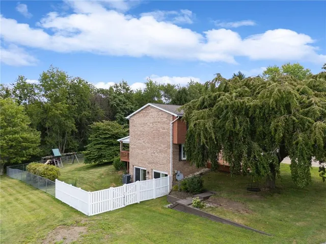 a view of a house with swimming pool and sitting area