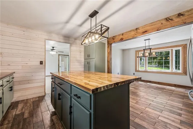 a kitchen with a granite countertop sink and wooden floor