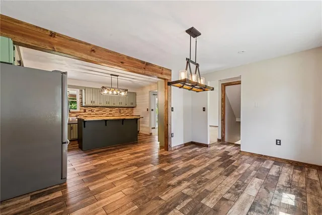a view of a kitchen with a sink and wooden floor