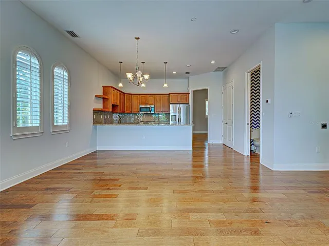 a kitchen with stainless steel appliances granite countertop a refrigerator a stove top oven a sink and dishwasher