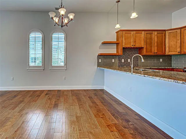 a kitchen with stainless steel appliances granite countertop a stove and a microwave