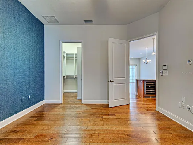 wooden floor in a hall with an empty room
