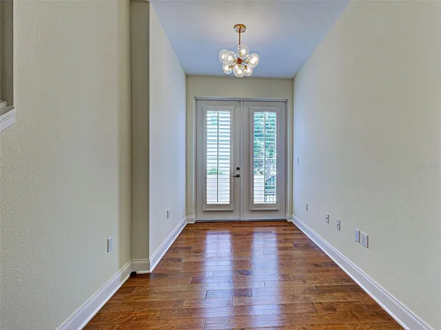 a view of a swimming pool with a patio and a chairs