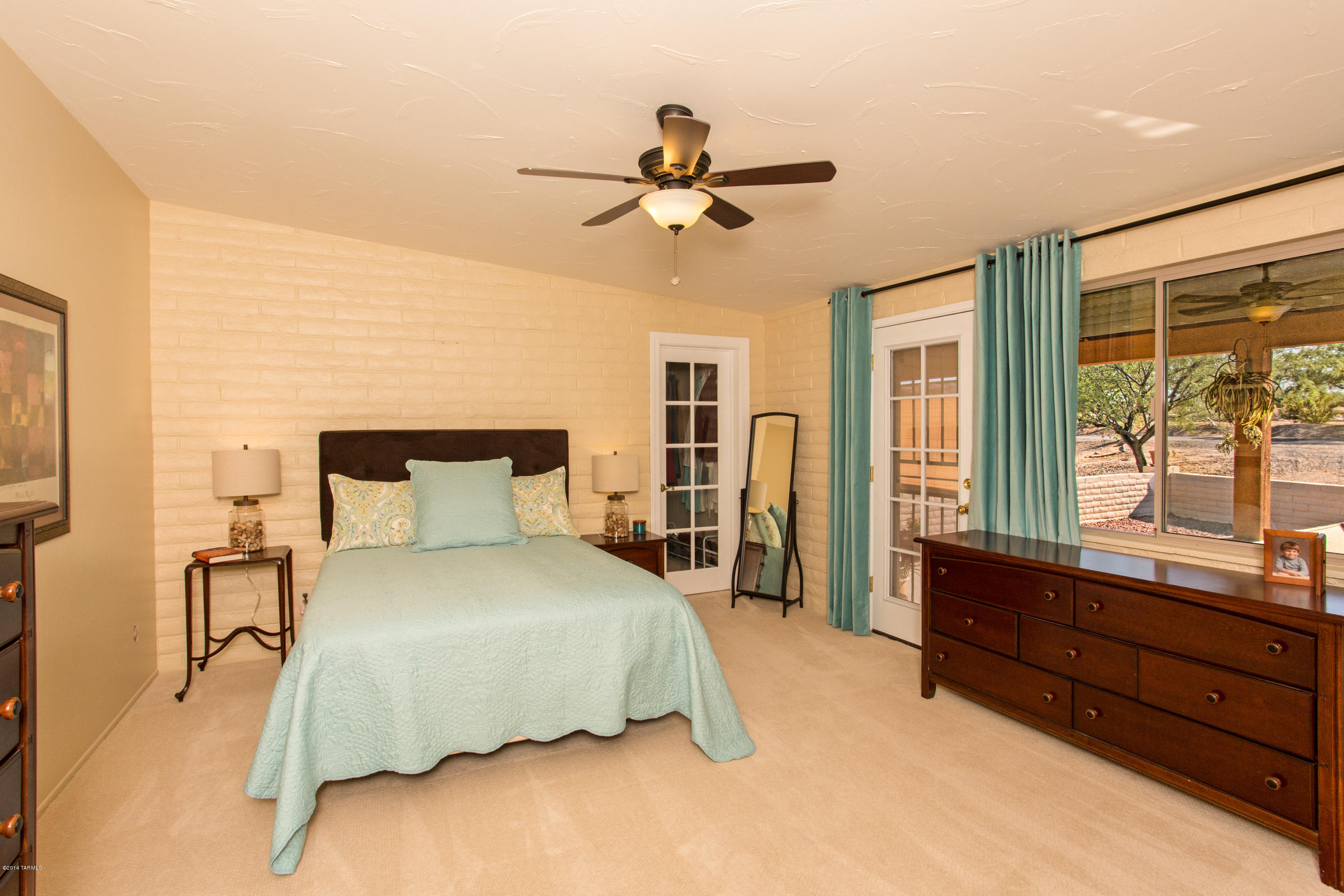 3240 North Webster Road Tucson, AZ 85750 - Photo 13 of 26 a bedroom with a bed and wooden floor