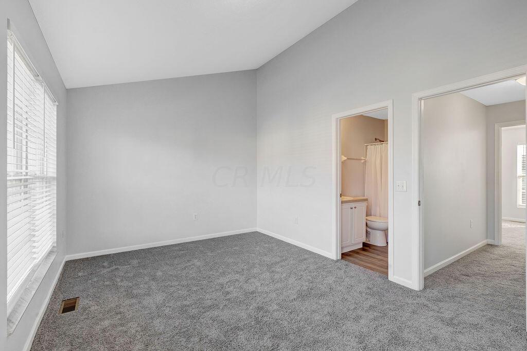 6345 Needletail Road, Unit 24634 Columbus, OH 43230 - Photo 21 of 58 • New gray carpet ~ 2021 • Gray painted walls • Vaulted ceiling • Ceiling light • Full wall closet with double sliding doors • 2” blinds