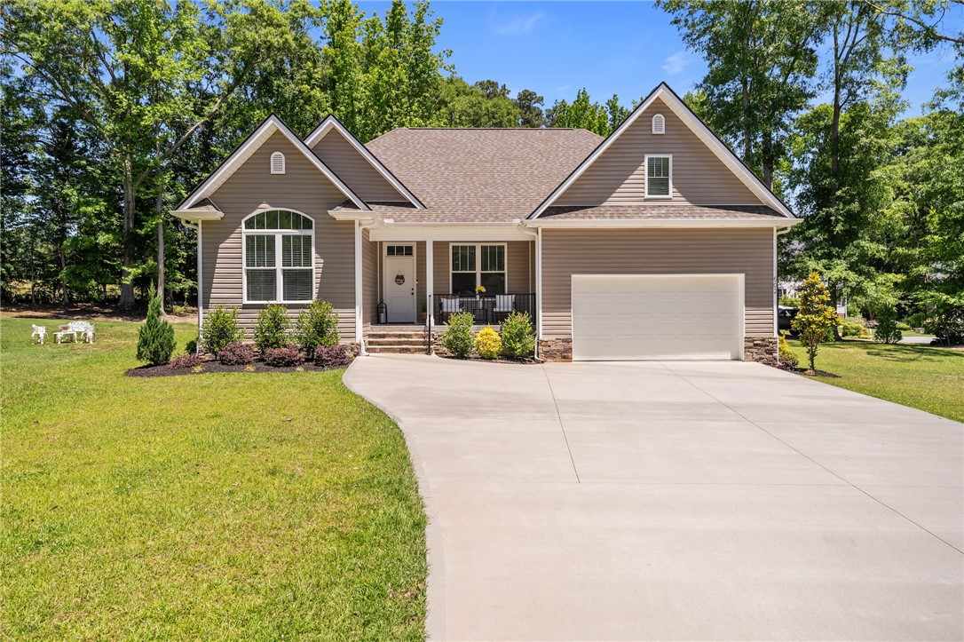 This charming home offers a welcoming facade with a well-maintained lawn and mature trees.