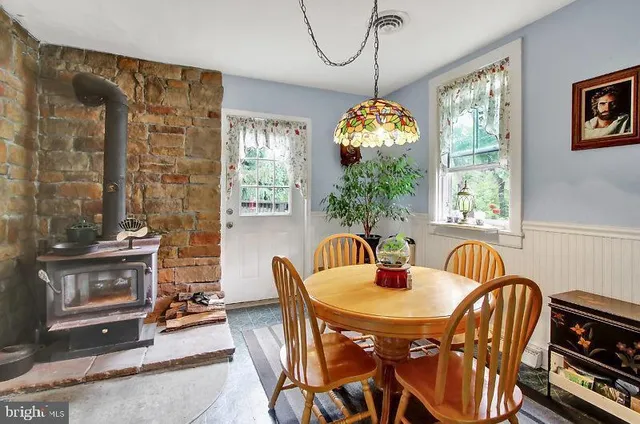 a dining room with furniture a chandelier and window