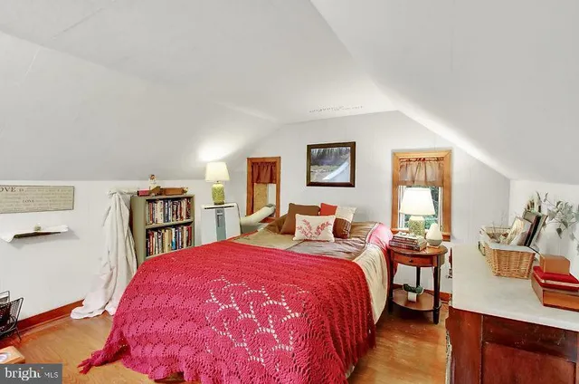 a bed room with a bed and a book shelf