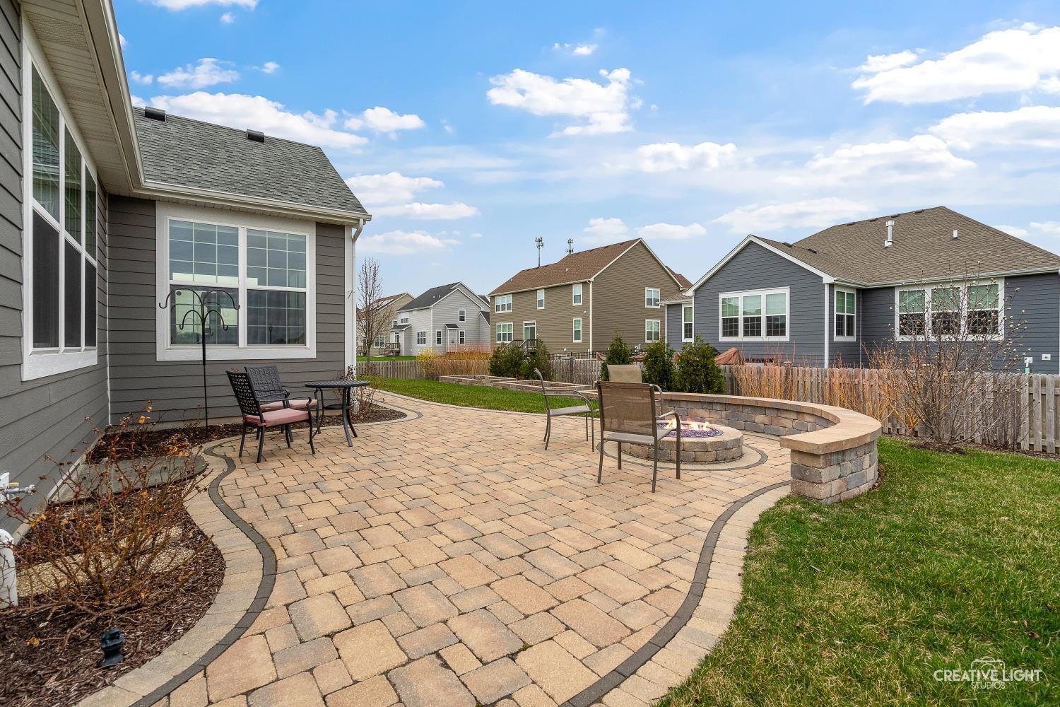 3638 Emerald Road Elgin, IL 60124 - Photo 16 of 18 a view of a house with backyard sitting area and garden