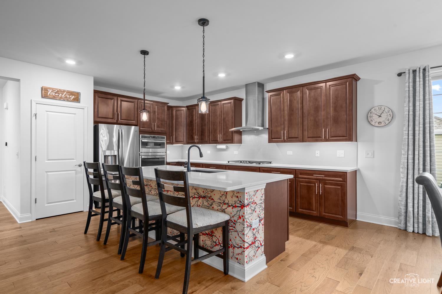 3638 Emerald Road Elgin, IL 60124 - Photo 5 of 18 a kitchen with stainless steel appliances granite countertop a kitchen island hardwood floor sink and stove