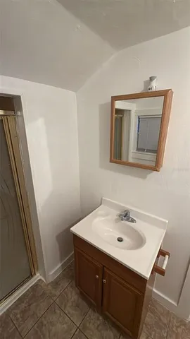 a bathroom with a sink a mirror and vanity