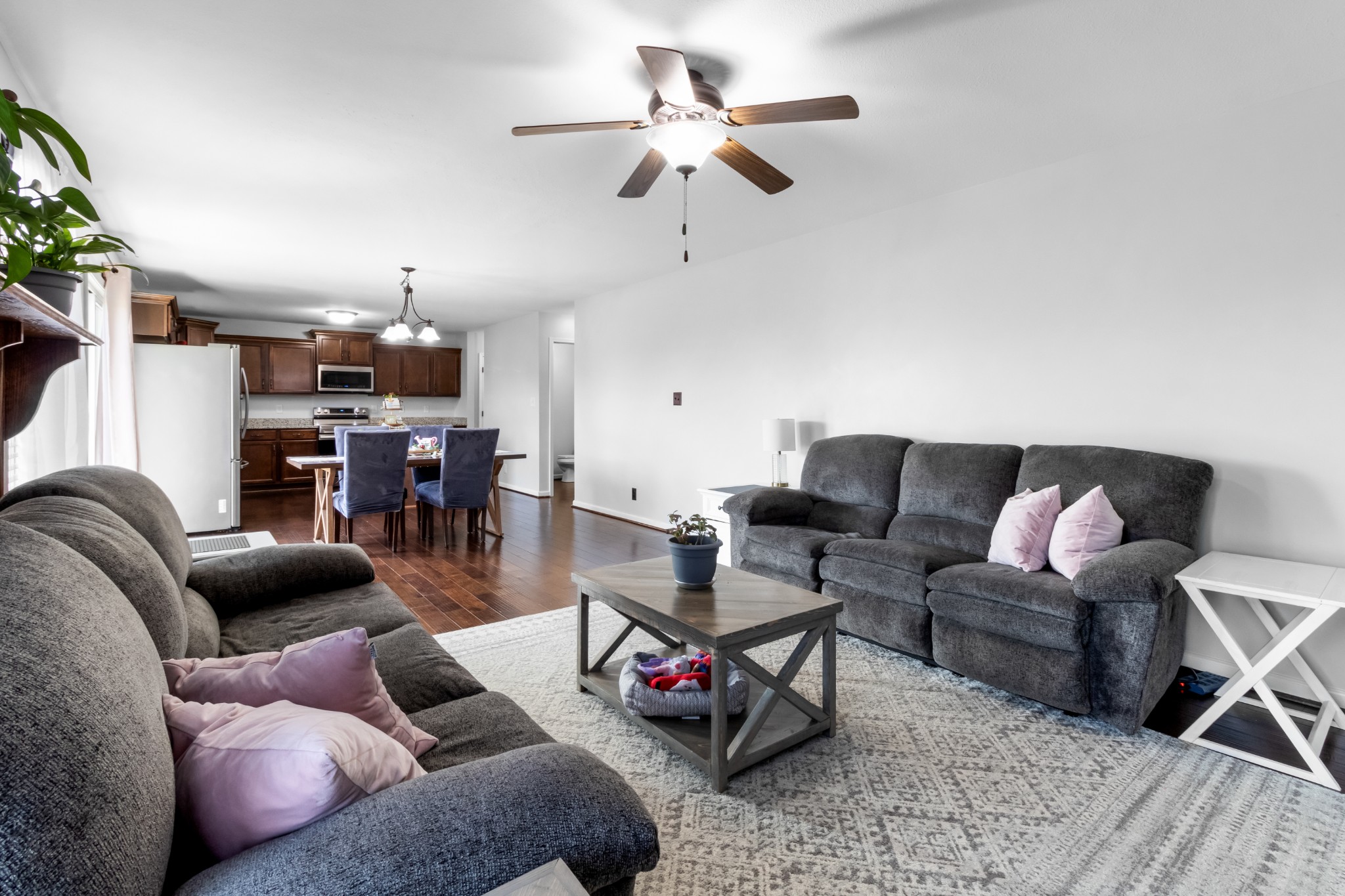 1069 Castlerock Drive Clarksville, TN 37042 - Photo 7 of 25 a living room with furniture a ceiling fan and a rug