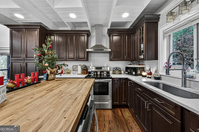 a kitchen with lots of counter top space and wooden floor