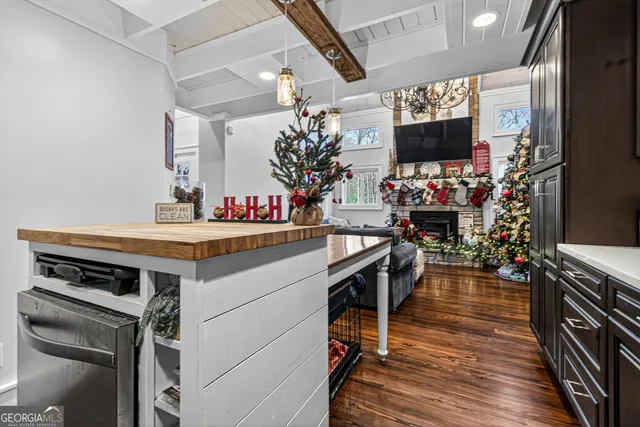 a kitchen view of a kitchen island wooden floor and a fireplace