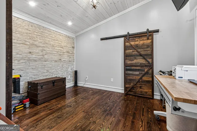 a view of a livingroom with wooden floor and furniture