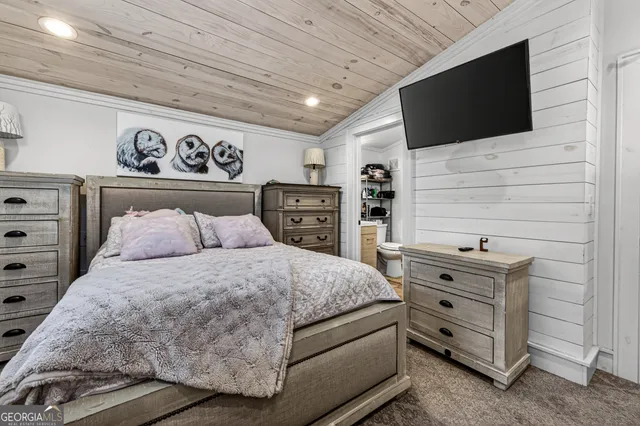 a bedroom with a bed and flat screen tv