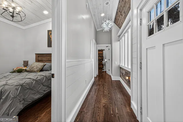 a view of a bedroom with wooden floor