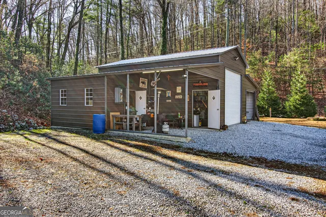 a view of a house with backyard and porch
