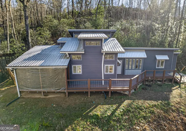 a view of a house with backyard and deck