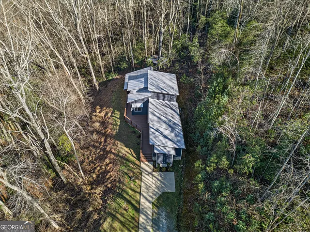 a view of a roof deck with table and chairs with wooden floor and fence