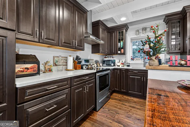 a kitchen with stainless steel appliances granite countertop a sink stove and cabinets