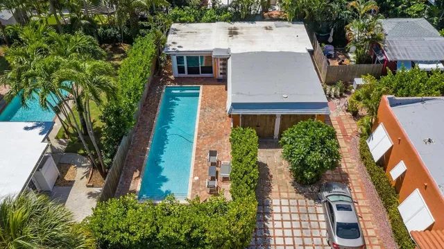 an aerial view of a house with a yard