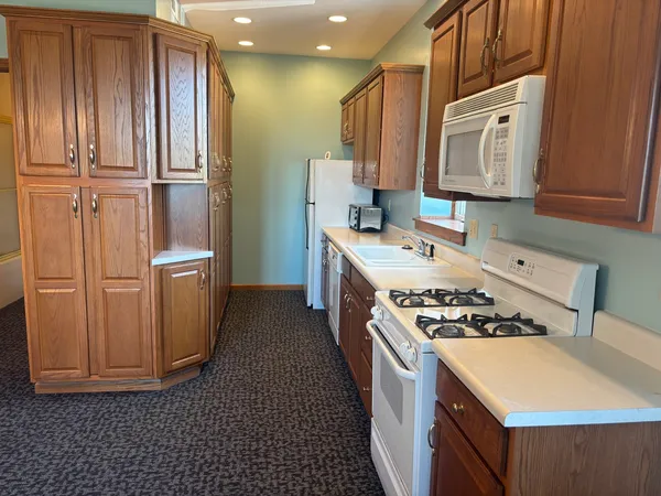 a kitchen with a cabinets stove and sink