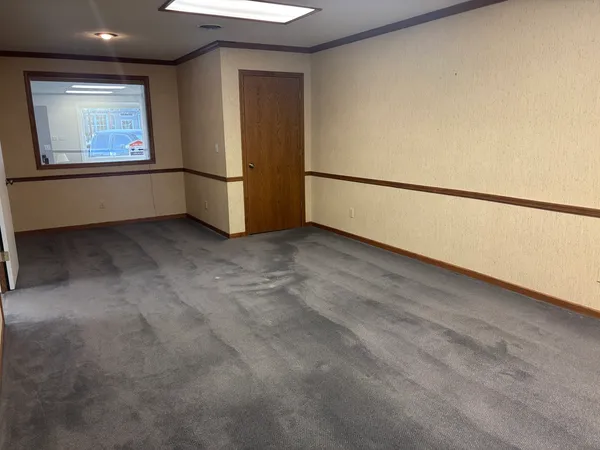 a kitchen with cabinets and window