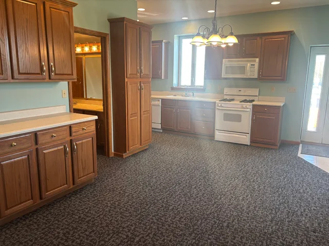 a kitchen with stainless steel appliances granite countertop a refrigerator and cabinets