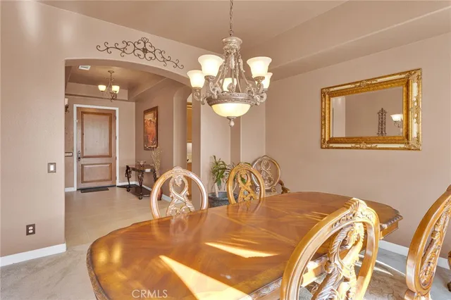 a living room with furniture kitchen view and a large window