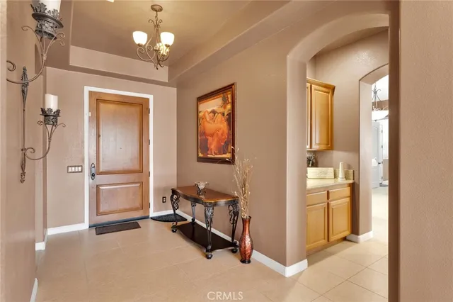 a kitchen with kitchen island wooden cabinets and refrigerator