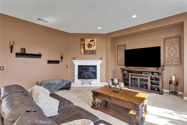 a large kitchen with kitchen island a sink and a stove top oven with wooden floor