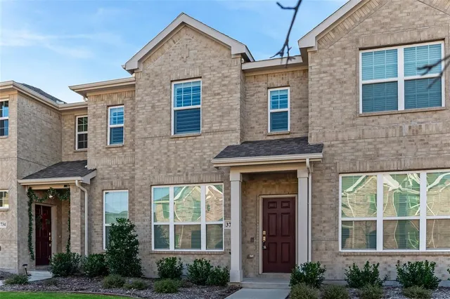 a front view of a brick house many windows