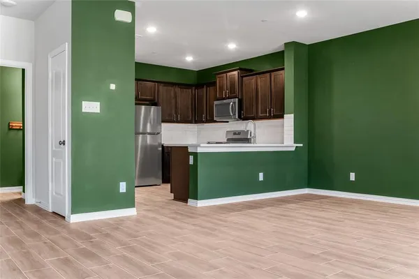 a view of kitchen with a refrigerator and a sink